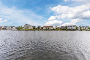 a large body of water with buildings in the background at The Boathouse Lodge in Harderwijk