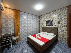 a bedroom with a bed with a teddy bear on it at Queen Maricel Inn in Virac