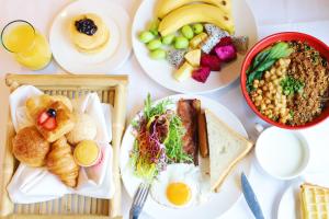 three plates of food on a table with breakfast foods at Chongqing Marriott Hotel in Chongqing