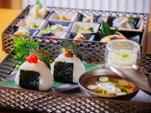 a tray filled with sushi and a bowl of soup at Hotel Monterey Sendai in Sendai