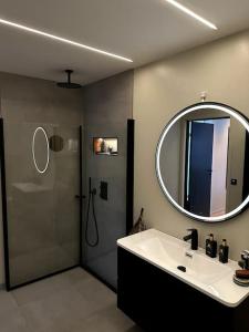 a bathroom with a shower and a sink and a mirror at Enebolig Trondheim, familievennlig, nytt 2023 in Trondheim