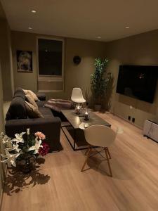 a living room with a couch and a table at Enebolig Trondheim, familievennlig, nytt 2023 in Trondheim