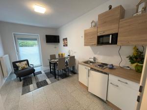 a kitchen with a table and a dining room at Ferienwohnung Natascha in Bad Gleichenberg