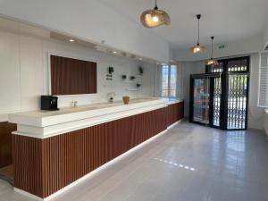 a large kitchen with a counter and a lobby at Hotel Clermont Airport in Aulnat