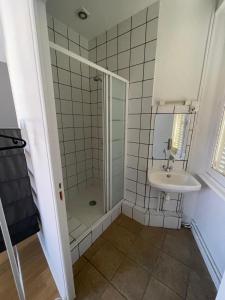 a bathroom with a shower and a sink at Hotel Clermont Airport in Aulnat +22 photos