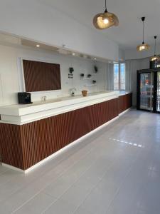 a lobby with a long counter in a building at Hotel Clermont Airport in Aulnat