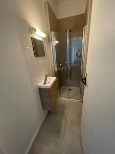 a bathroom with a shower and a sink at Hotel Clermont Airport in Aulnat