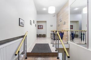 a hallway of a gym with a staircase and a stair case at Silvija House in Vilnius