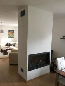 a living room with a fireplace and a couch at Johnyho Bydlení Velikovská 10, Zlín-Štípa in Zlín