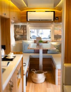 a kitchen with a table in an rv at Camperisti Club Laiya in San Juan +30 photos
