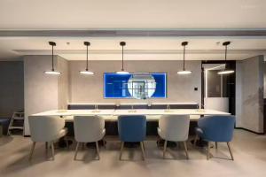 a dining room with a large white table and chairs at Atour Light Hotel Wuxi Nanchang Street Sanyang Plaza in Wuxi