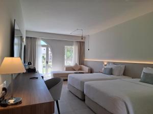 a hotel room with two beds and a couch at Reef Oasis Beach Aqua Park Resort in Sharm El Sheikh