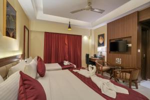 Postel nebo postele na pokoji v ubytování Park Avenue Hotel & Apartments Trichy