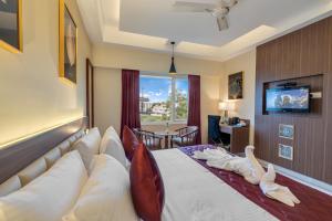 Postel nebo postele na pokoji v ubytování Park Avenue Hotel & Apartments Trichy