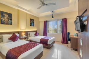 Postel nebo postele na pokoji v ubytování Park Avenue Hotel & Apartments Trichy