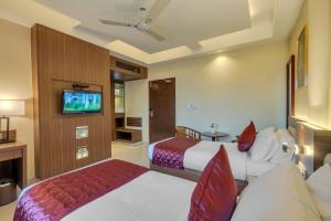 Postel nebo postele na pokoji v ubytování Park Avenue Hotel & Apartments Trichy