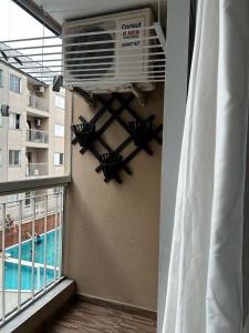 a room with a balcony with a air conditioner at Rental São José - Acomodações Residenciais III in São José