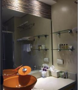 a bathroom with a sink and a mirror at Cozy 1BR Condo at SM Lights Mandaluyong City in Manila