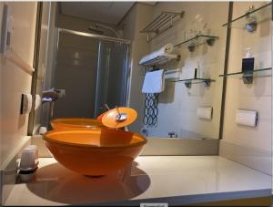 a bathroom with a wooden toilet and a shower at Cozy 1BR Condo at SM Lights Mandaluyong City in Manila +1 photo