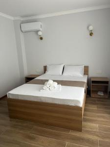 a bedroom with a bed with two towels on it at Grand ARIA Hotel in Almaty +11 photos