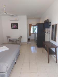 a bedroom with a bed and a desk and a table at Smile house in Karon Beach
