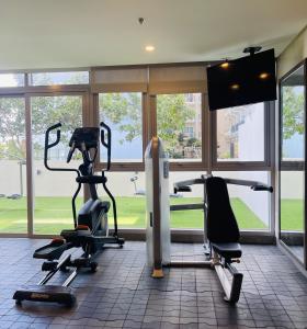 a gym with two treadmills and two exercise bikes at The Palladium Retreat in Iloilo City