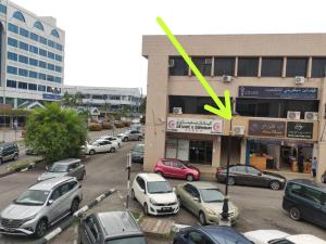 a parking lot with cars parked in front of a building at EZ Cabins in Bandar Seri Begawan