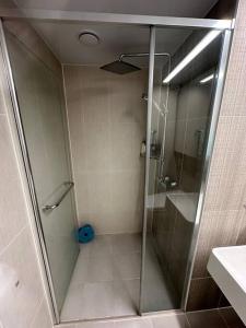 a shower with a glass door in a bathroom at Byeollae Station I-park Suite Apartment 16F in Namyangju +16 photos