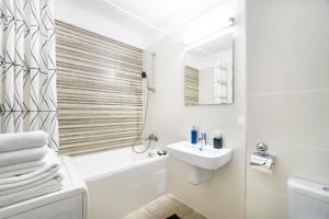 a white bathroom with a sink and a toilet and a shower at Jasmine Luxury Aviatiei in Herăstrău +25 photos