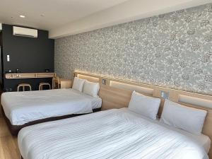 Postel nebo postele na pokoji v ubytování Kansai International Airport Hotel 11