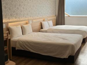 Postel nebo postele na pokoji v ubytování Kansai International Airport Hotel 11