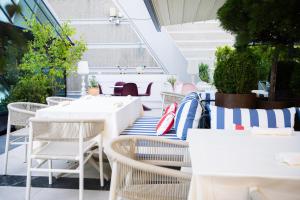 an outdoor seating area with tables and chairs at Crowne Plaza Belgrade by IHG in Belgrade
