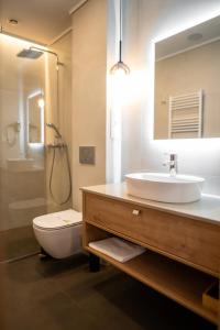a bathroom with a sink and a toilet and a mirror at No Pardon Hotel in Satu Mare +20 photos