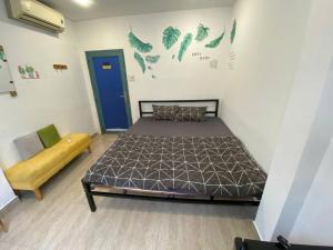 a bedroom with a bed and a couch in it at THE JOYS HOSTEL in Ho Chi Minh City