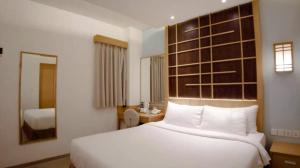 Llit o llits en una habitació de UNUMA HOTEL