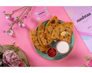 a plate of food with crackers and sauce on a table at Uno Hotel Heathrow Windsor in Slough +2 photos