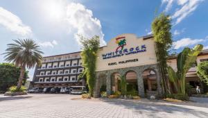 a building with a sign that reads wilderness hotel at Whiterock Beach Hotel and Waterpark in Subic