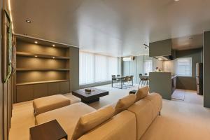 a living room with a couch and a table at Nishimachi BASE in Sapporo