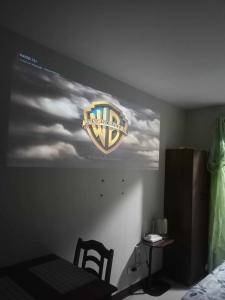 a sign on the wall of a room with a picture of aiership at Laugh tale Staycation in Suba