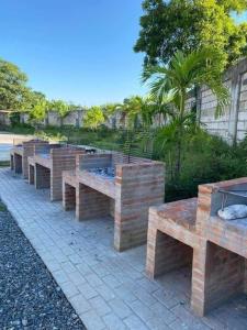 a row of wooden benches sitting on a sidewalk at Laugh tale Staycation in Suba
