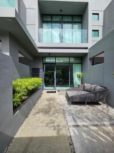 a building with a couch in front of it at The Langkawi Luxury - Private Pool Villas & Rooftop Sunset in Pantai Cenang
