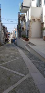 an empty street next to a white building at Gárgara Bed and Breakfast in Vico del Gargano