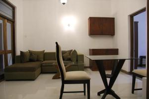 a living room with a couch and a table at Sagala Bungalow in Kalutara