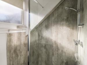 a shower with a glass door in a bathroom at Skyelands in Wooler +27 photos