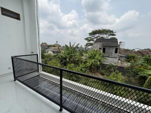 a balcony with a view of a house at Griya Tegalweru Palagan Homestay Jogja in Ngaglik