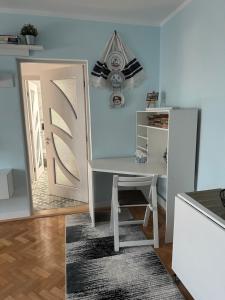 a white desk and chair in a room with a mirror at Cozy Comforts aprt in Cugir in Cugir