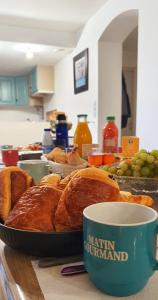 a table with a plate of bread and a cup of coffee at Le Clos Gagné in Bais +21 photos