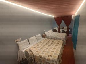 a bedroom with two beds in a room at Peaceful Abode in Auroville