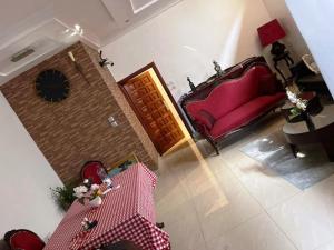 a living room with a red couch and a table at AHoefa in Lomé
