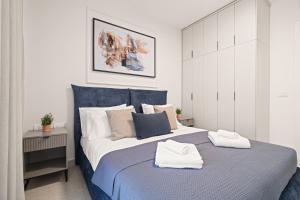 a bedroom with a large bed with two towels on it at Yashar Savyon View JLM - 1bd 16th floor in Jerusalem